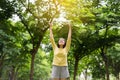 Asian woman enjoying and freedom with open hands,Female rise hands up enjoy nature outdoor Royalty Free Stock Photo