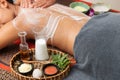 Asian woman enjoying a salt scrub massage at spa Royalty Free Stock Photo