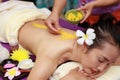 Asian woman enjoying a salt scrub massage at spa Royalty Free Stock Photo