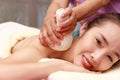 Asian woman enjoying a salt scrub massage at spa Royalty Free Stock Photo