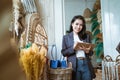 Asian woman entrepreneurs take notes on a handmade flower background