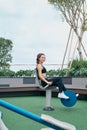 Asian woman exercising at outdoors gym playground equipment Royalty Free Stock Photo