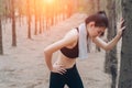 Asian woman exhausted or tired after training workout at forest