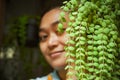 Asian woman with exotic dischidia houseplants