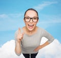 Asian woman in eyeglasses with finger up