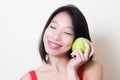 Asian woman face smiling with closed eyes with green apple Royalty Free Stock Photo