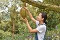 Asian woman farmer holding Durian is a king of fruit in Thailand Royalty Free Stock Photo