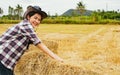 Asian female farmer selling rice straw as agricultural product. Royalty Free Stock Photo