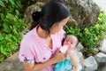Asian woman feeding her baby in park from top Royalty Free Stock Photo