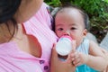 Asian woman feeding her baby from top Royalty Free Stock Photo