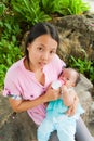 Asian woman feeding her baby top vertical Royalty Free Stock Photo