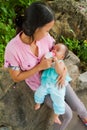 Asian woman feeding her baby top vertical Royalty Free Stock Photo