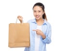 Asian woman finger point to shopping bag Royalty Free Stock Photo