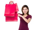 Asian woman finger point to shopping bag Royalty Free Stock Photo