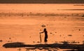 Asian Woman fishing in the river, silhouette at sunset