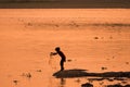 Asian Woman fishing in the river, silhouette at sunset
