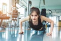 Asian woman fitness girl do pushing ups at fitness gym. Healthcare and Healthy concept. Training and Body build up theme. Royalty Free Stock Photo