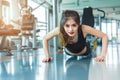 Asian woman fitness girl do pushing ups at fitness gym. Healthcare and Healthy concept. Training and Body build up theme. Royalty Free Stock Photo