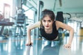 Asian woman fitness girl do pushing ups at fitness gym. Healthcare and Healthy concept. Training and Body build up theme. Royalty Free Stock Photo