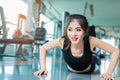 Asian woman fitness girl do pushing ups at fitness gym. Healthcare and Healthy concept. Training and Body build up theme. Royalty Free Stock Photo