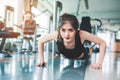 Asian woman fitness girl do pushing ups at fitness gym. Healthcare and Healthy concept. Training and Body build up theme. Strength Royalty Free Stock Photo