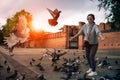Asian woman and flying pigeon in chiang mai northern of thailand Royalty Free Stock Photo