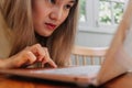 Asian woman focus and concentrate work online in the computer laptop in cafe Royalty Free Stock Photo