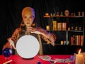 Asian woman fortune teller using divine magical power crystal ball to forecast psychic future luck