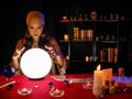 Asian woman fortune teller with crystal ball to forecast psyshic future luck