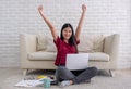 Asian woman freelancer arms up and smile for success working on