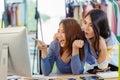 Asian woman with friend exciting hand pointing at computer screen for happy young SME business owner concept