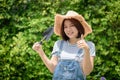 An Asian woman gardener is holding garden equipment tools Royalty Free Stock Photo