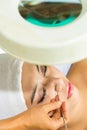 Asian woman getting a facial treatment in spa Royalty Free Stock Photo