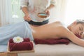 Asian woman getting a Salt Scrub Beauty Treatment in the Health Spa. Body Scrub. concept relaxation and health spa Royalty Free Stock Photo