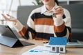 Asian woman gives the house keys to the client after signing a real contract and tenant, home insurance