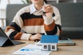 Asian woman gives the house keys to the client after signing a real contract and tenant, home insurance