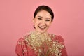 Asian woman glad to receiving a beautiful flower bouquet, Portrait of happy smiling middle age woman in casual clothes. Royalty Free Stock Photo