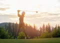 Asian Woman Golf Player Doing Golf Swing Tee Off On The Green Sunset Evening Time