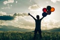 Asian woman on grassland with colored balloons