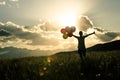 Asian woman on grassland with colored balloons