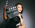 Asian women wear cheongsams and carry movie boards Royalty Free Stock Photo