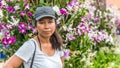 Asian woman surrounded by orchids Royalty Free Stock Photo