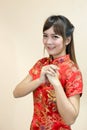 Asian woman greeting in traditional Chinese or cheongsam with hand lift welcome expression and lucky in chinese new year celebrati