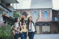 Asian woman group backpacker take a selfie on street together. Royalty Free Stock Photo