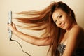 Asian woman with hair straightener