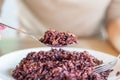 Asian woman hand eating healthy rice berry closeup