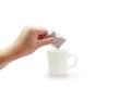 Asian woman hand holding dry tea bag of herb for making tea in white ceramic cup or mug on white background with copy space and Royalty Free Stock Photo