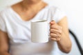 Asian woman hand holding a white cup of mug of hot black Americano coffee Royalty Free Stock Photo