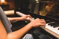 Asian woman hand playing keyboard of a piano in romantic atmosphere. Music instrument, solo pianist, song composer concept Royalty Free Stock Photo