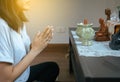 Asian woman with hand in praying buddha statue position Royalty Free Stock Photo